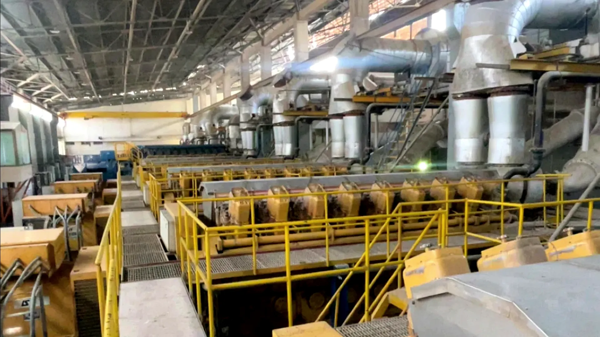 Industrial power hall with gensets, walkways, and plant piping